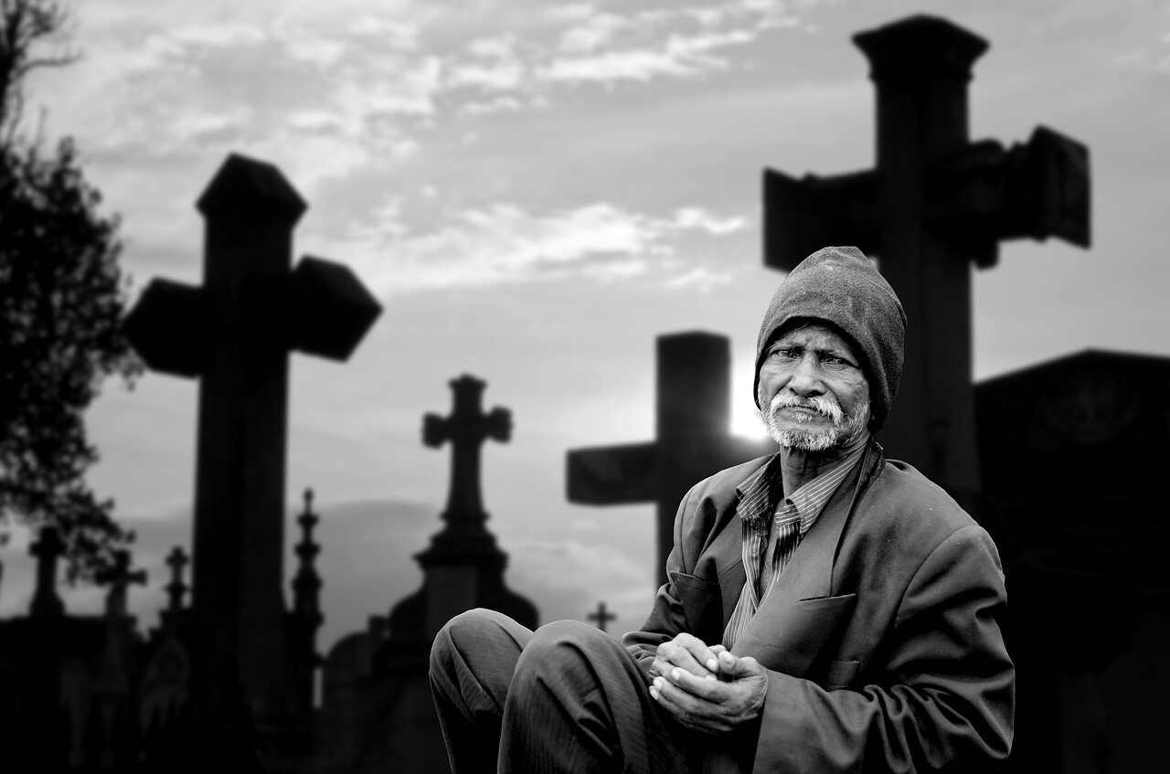 A man mourning a loved one at a cemetry in Atlanta, Georgia. 