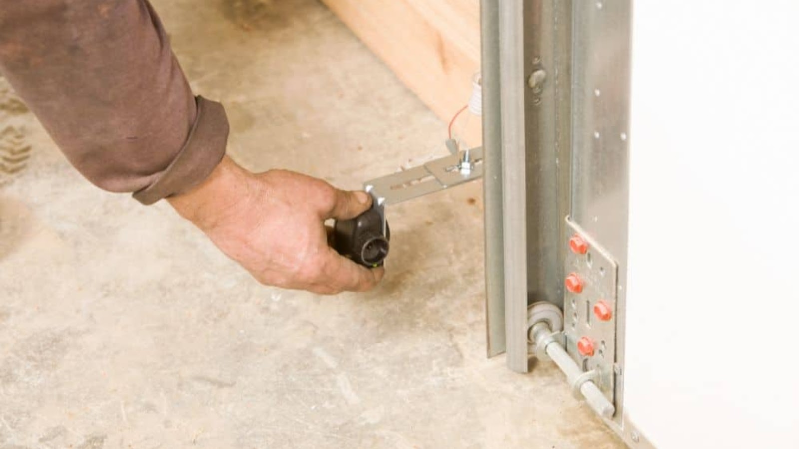 Adjusting the sensor to solve garage door not closing errors.