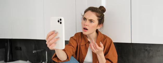 Can't follow someone on Instagram but not blocked: frustrated girl looking at her phone