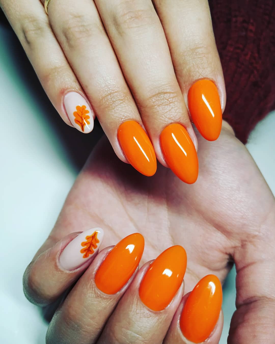 Close-up of hands with fall nail design having Autumnal Hues