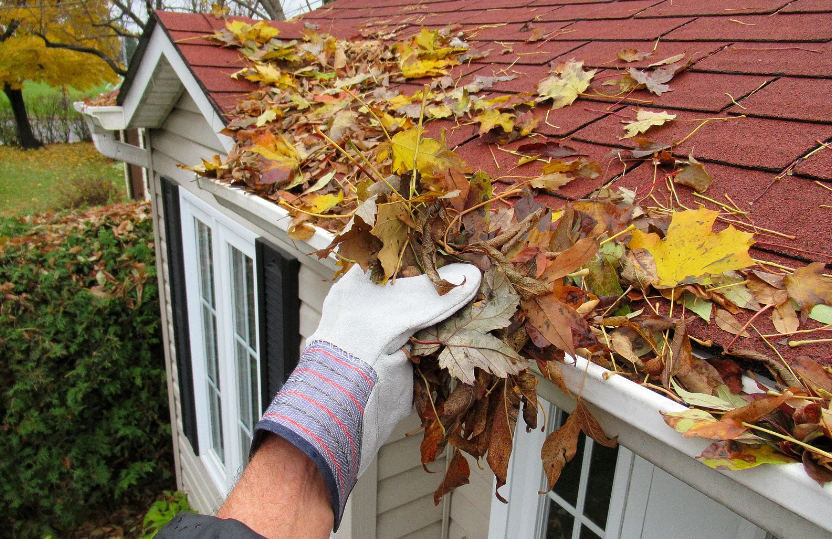 a person clearing off a roof