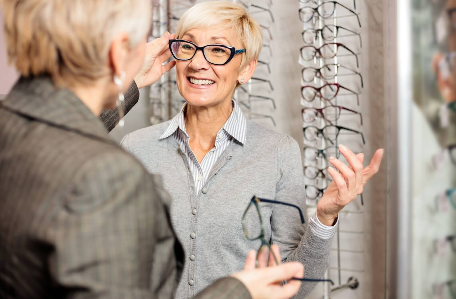  mature patient trying on glasses frames to select their new pair of progressive eyeglasses.