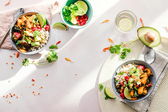 A table set with bowls of fresh, vibrant salads, featuring a variety of colorful vegetables and healthy ingredients, ready for a delicious meal