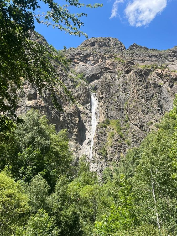 A waterfall in the mountainsAI-generated content may be incorrect.