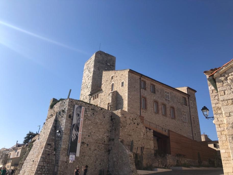 A stone building with a sign on the side

Description automatically generated