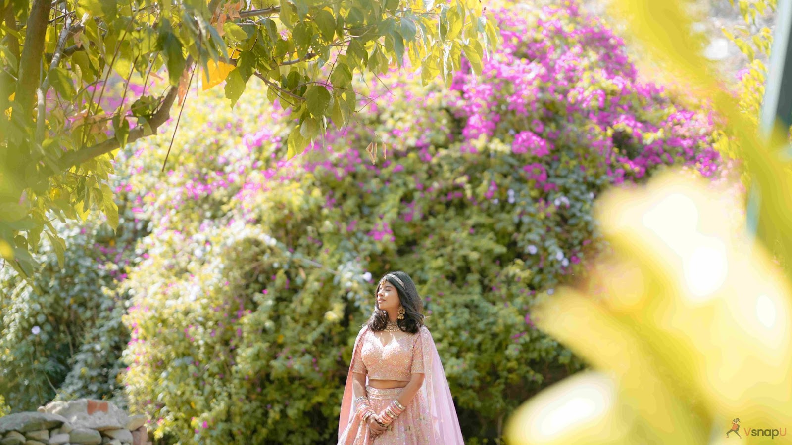 Elegant bride surrounded by lush greenery, embodying the tranquility of nature in wedding photography