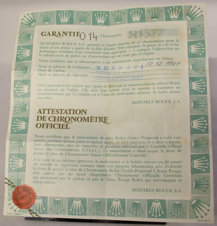 Vintage Rolex warranty and official chronometer certificate showing buyer details and authenticity seal