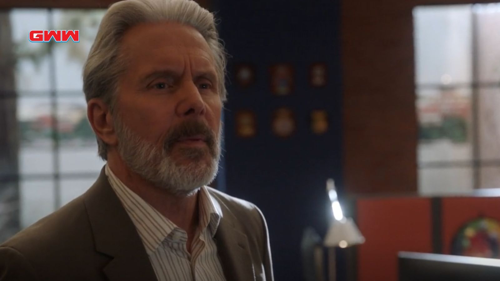 SSA Alden Parker with gray hair and beard looks serious in conversation.