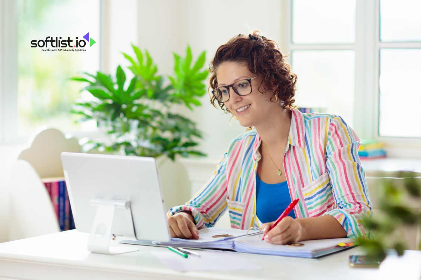 a smiling woman typing to her laptop