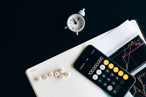 Free Black Remote Control Beside Silver Round Analog Wall Clock Stock Photo