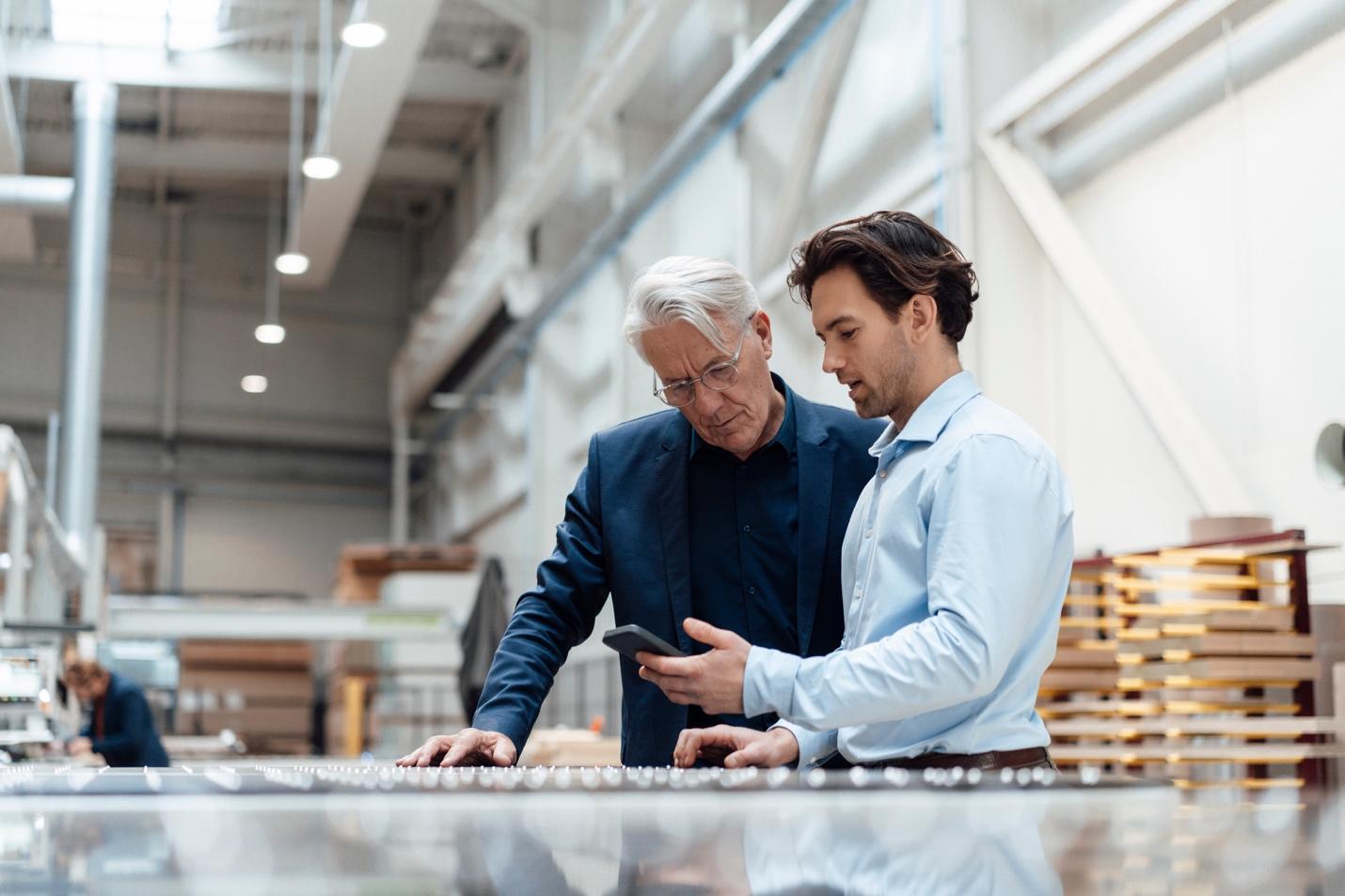 Two men looking at smartphone