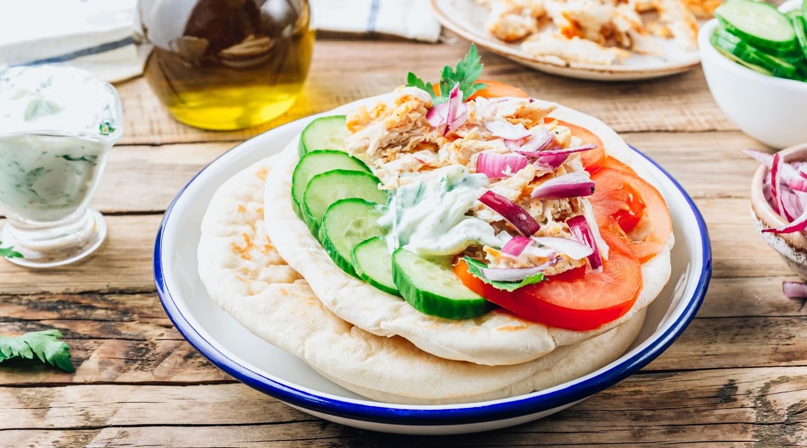 Fresh and healthy chicken gyro served on pita bread with sliced cucumbers, tomatoes, red onions, and topped with a light tzatziki sauce. A nutritious Mediterranean-inspired meal option, perfect for those looking for a balanced and flavorful dish in Mississauga, recommended by our registered dietitian.