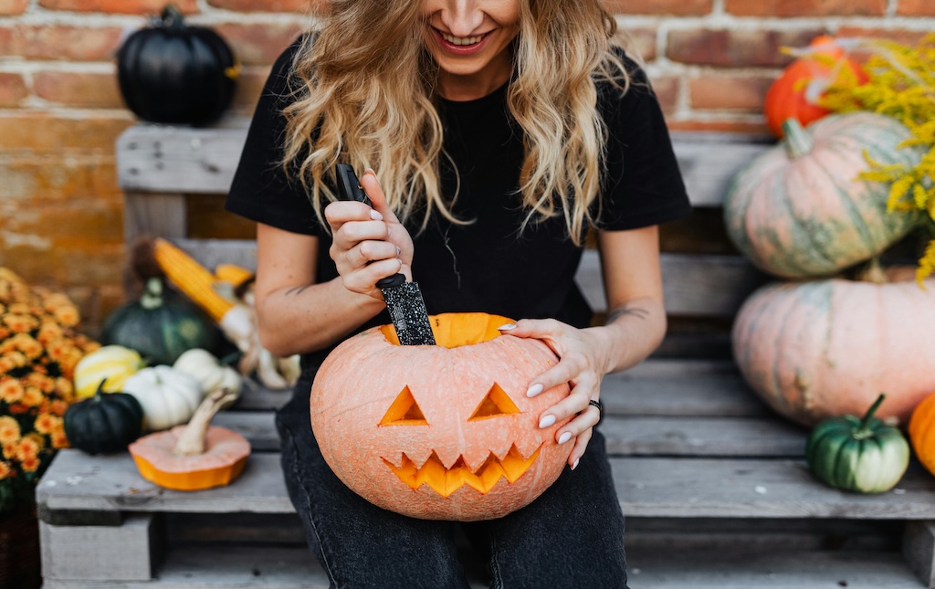 woman carving pumpkin