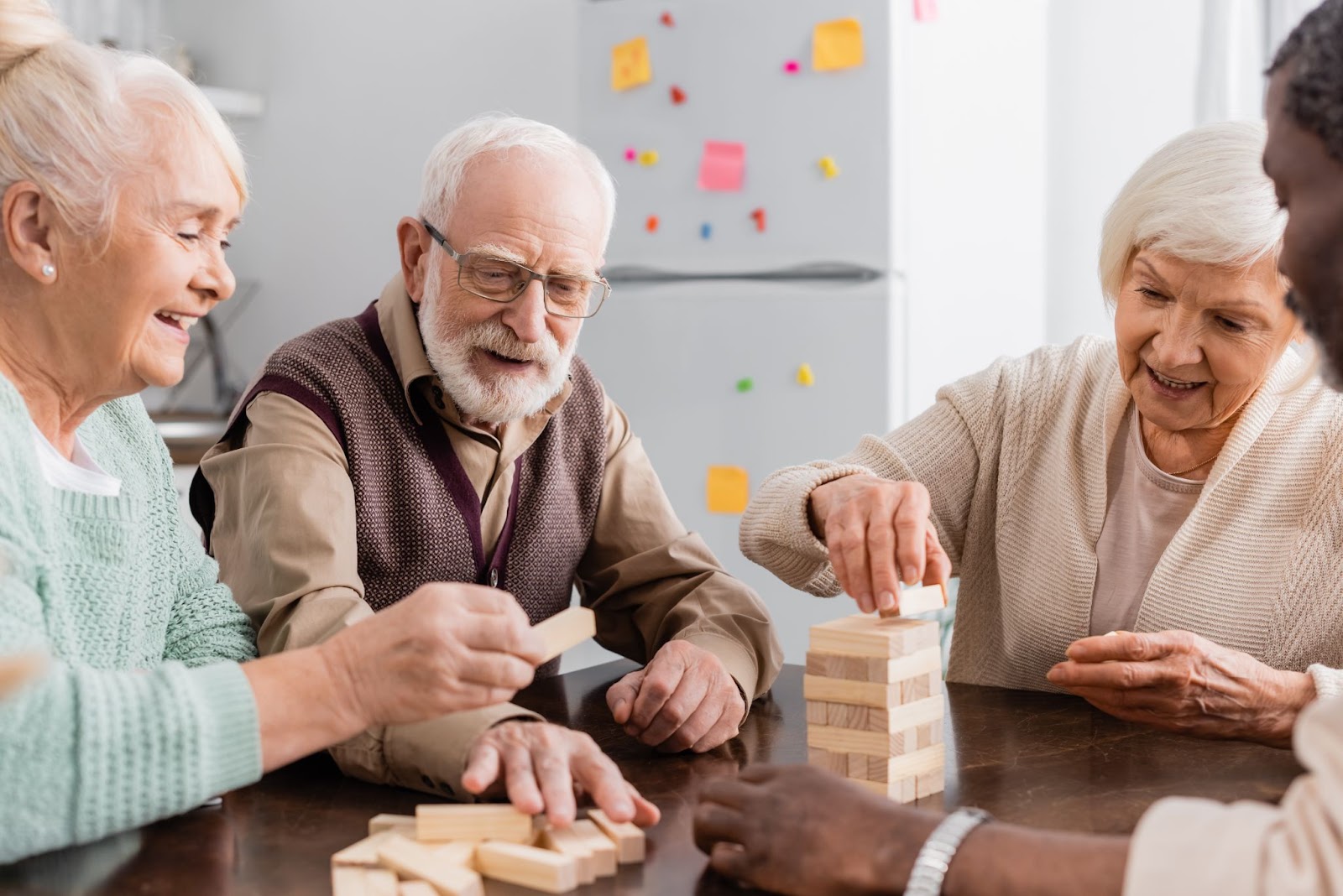 A group of happy seniors playing a tabletop game together.