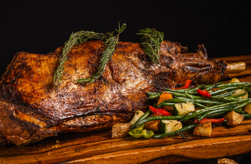 A cooked meat with vegetables on a wooden board

AI-generated content may be incorrect.