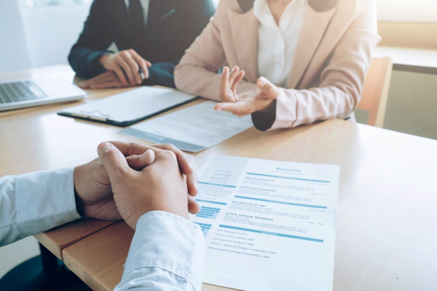 A group of people sitting at a table AI-generated content may be incorrect.