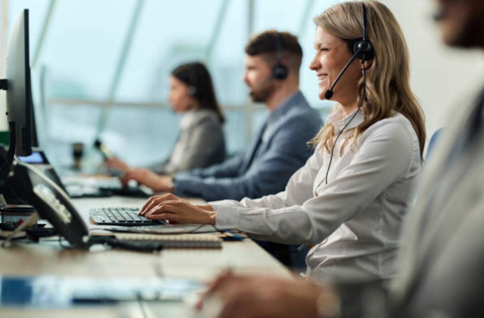 A group of people sitting at a desk

Description automatically generated