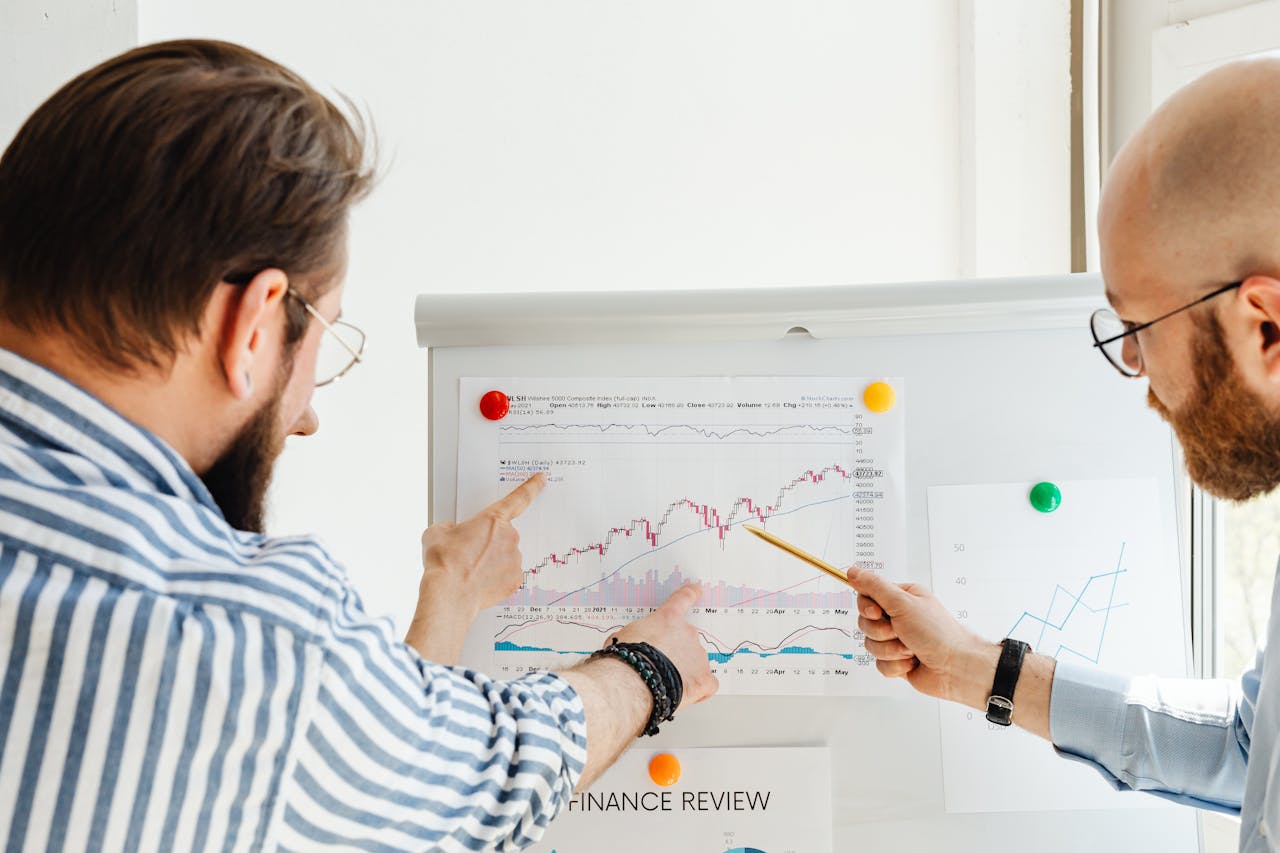 3 men analyzing the infographic showing steps to utilize a business plan for effective business growth and development strategies.