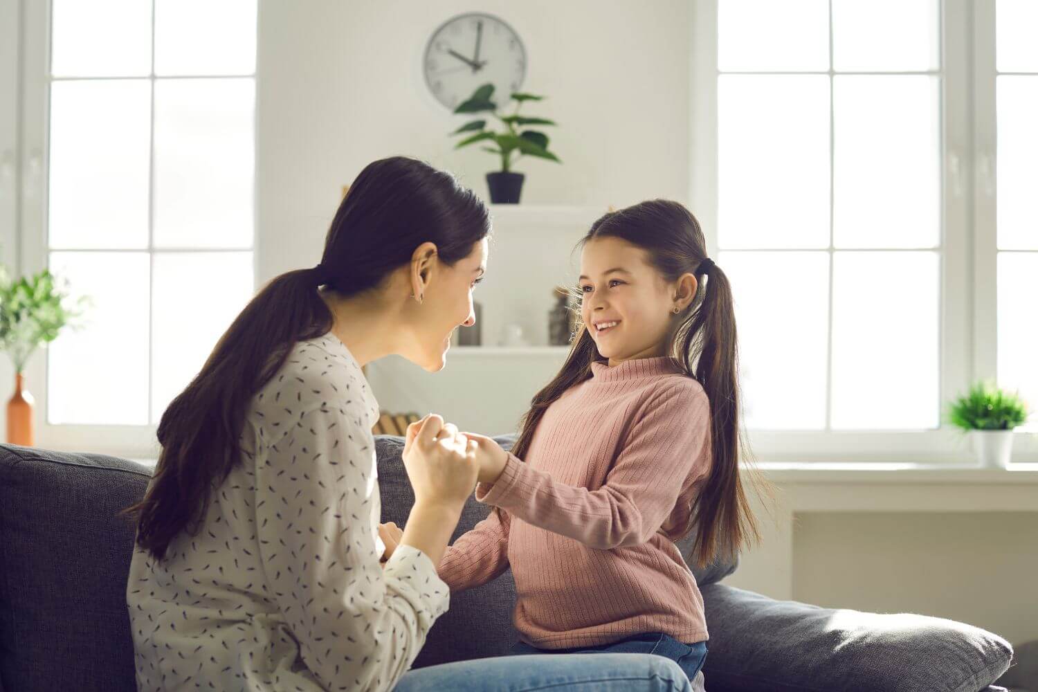 Mother discussing new pregnancy with her young daughter