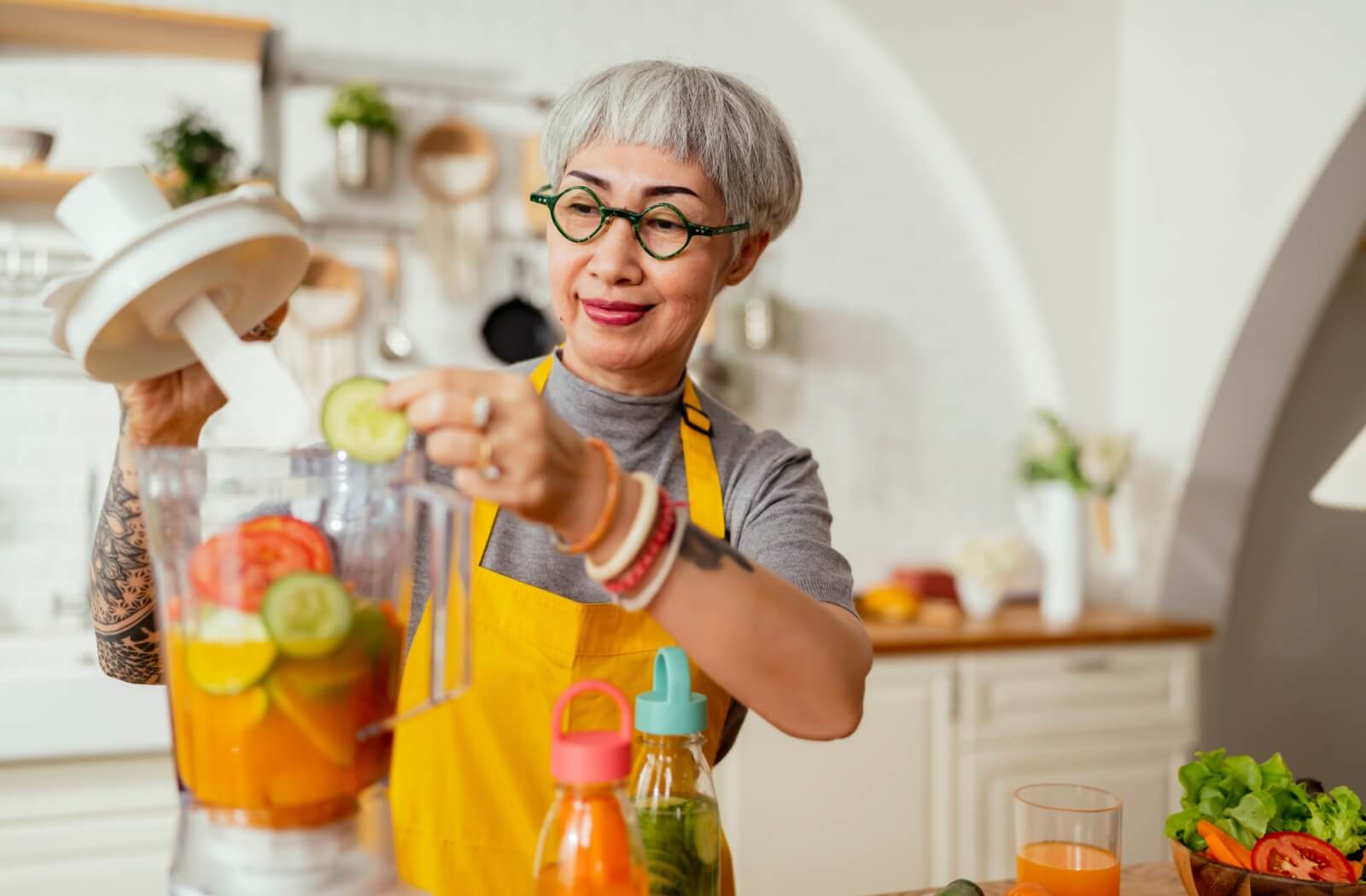 A happy senior prepares a nutritious smoothie to support their physical and cognitive health.