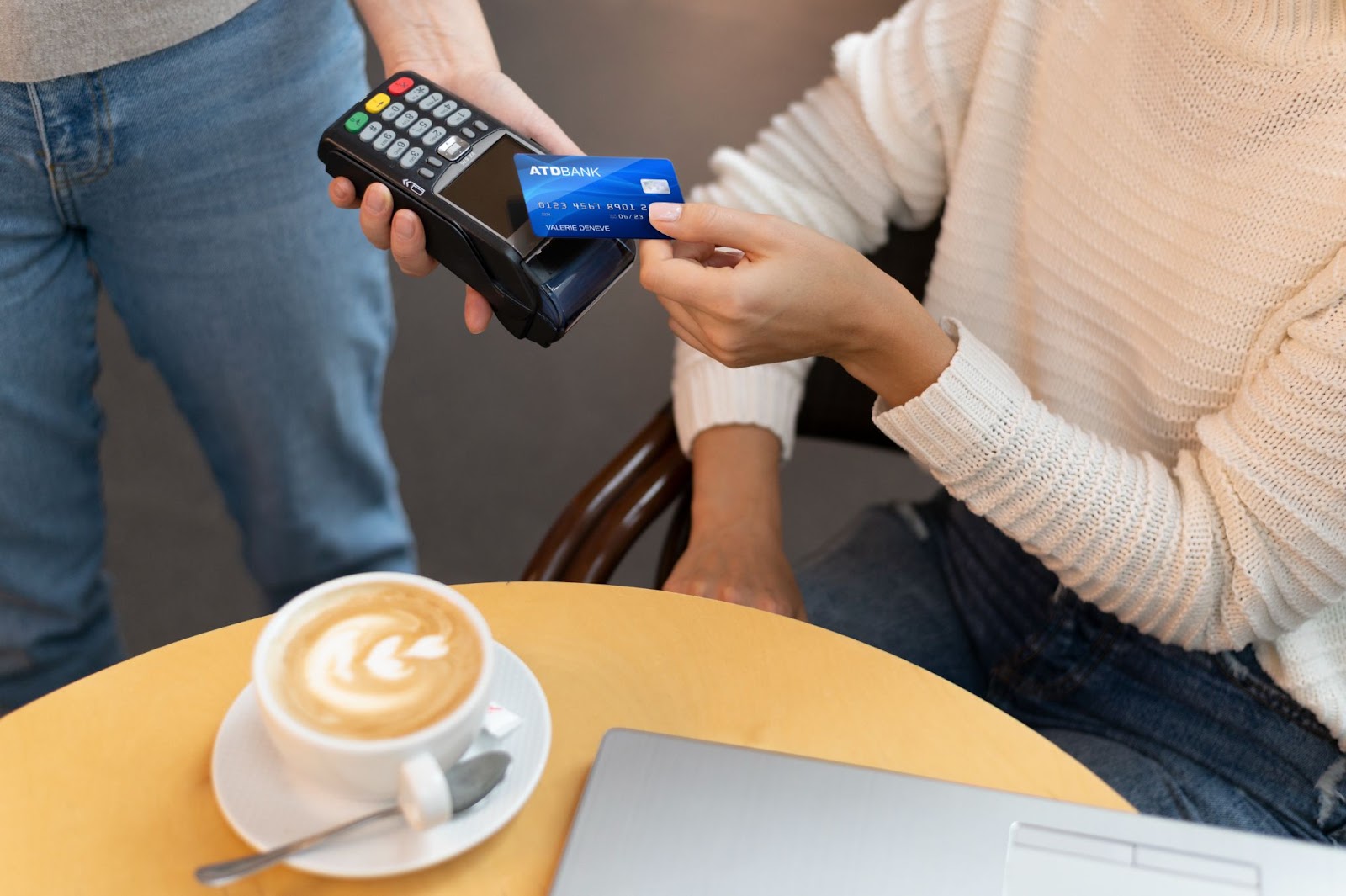 person paying for coffee with credit card