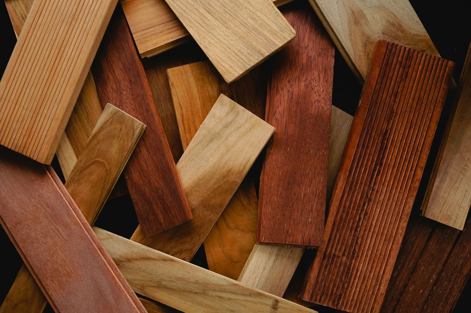 Assorted wood material samples in various tones and grains used in cabinet manufacturing and formaldehyde content assessment.