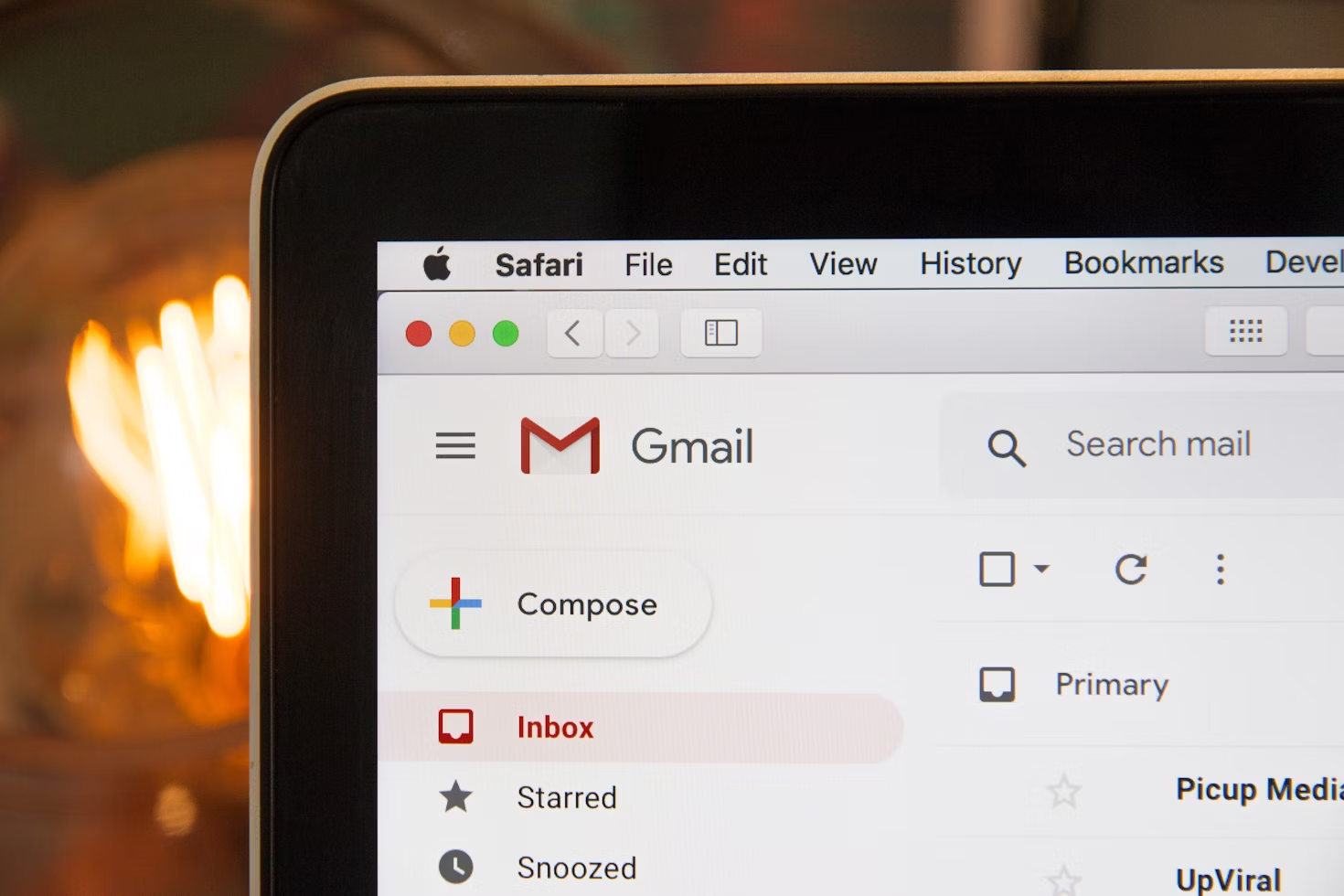 Close-up of a Gmail inbox screen on a computer, with the Compose button visible