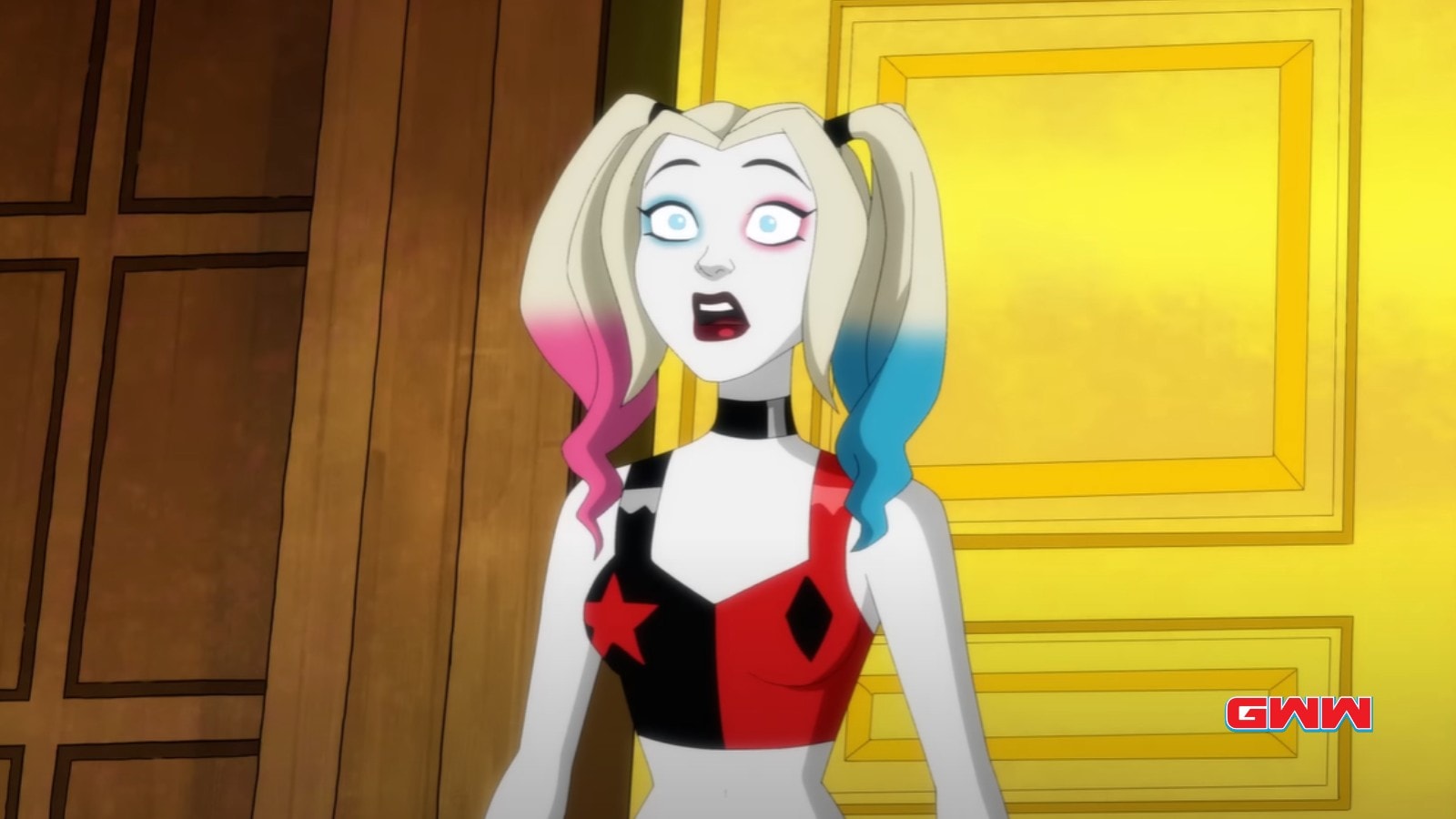 Harley Quinn in classic attire looking surprised in a golden room