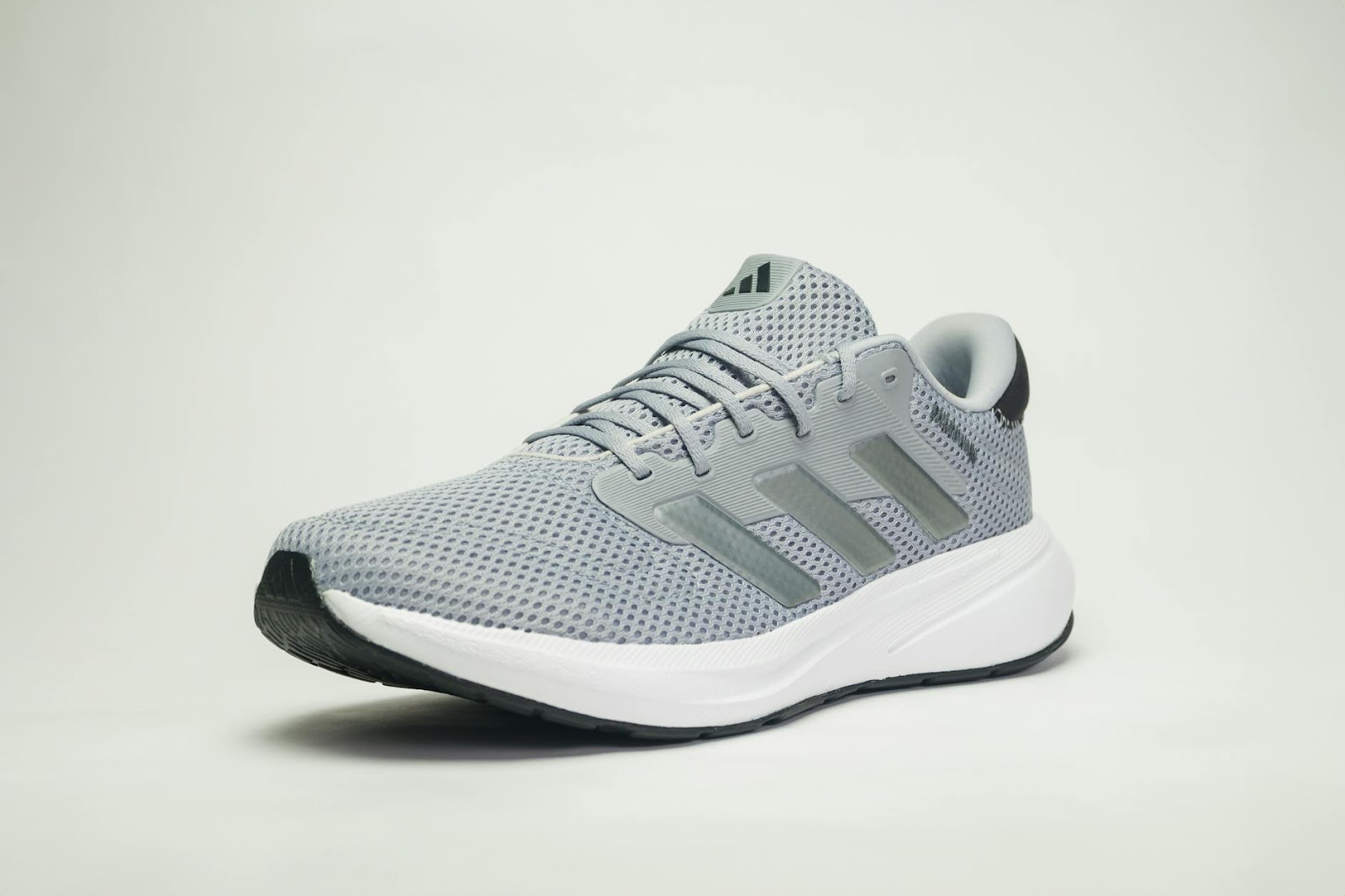 https://www.pexels.com/photo/stylish-adidas-gray-running-shoe-on-white-background-28879459/