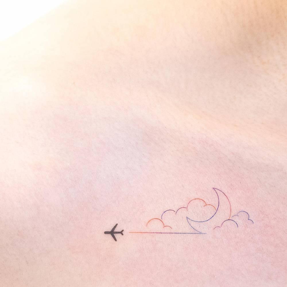 Fine line style airplane, cloud and moon tattoo located