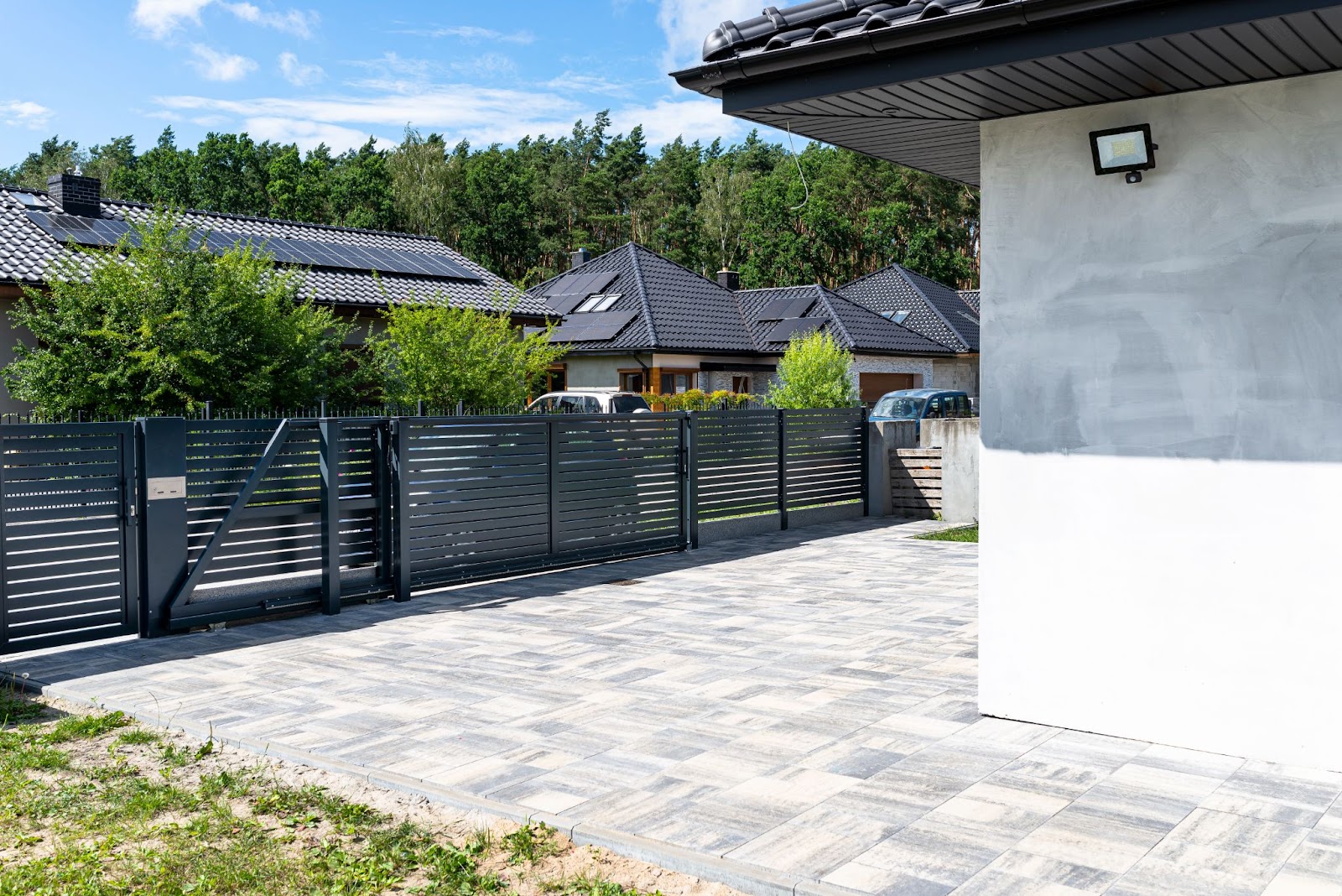 Modern steel fencing around a home and front yard. 