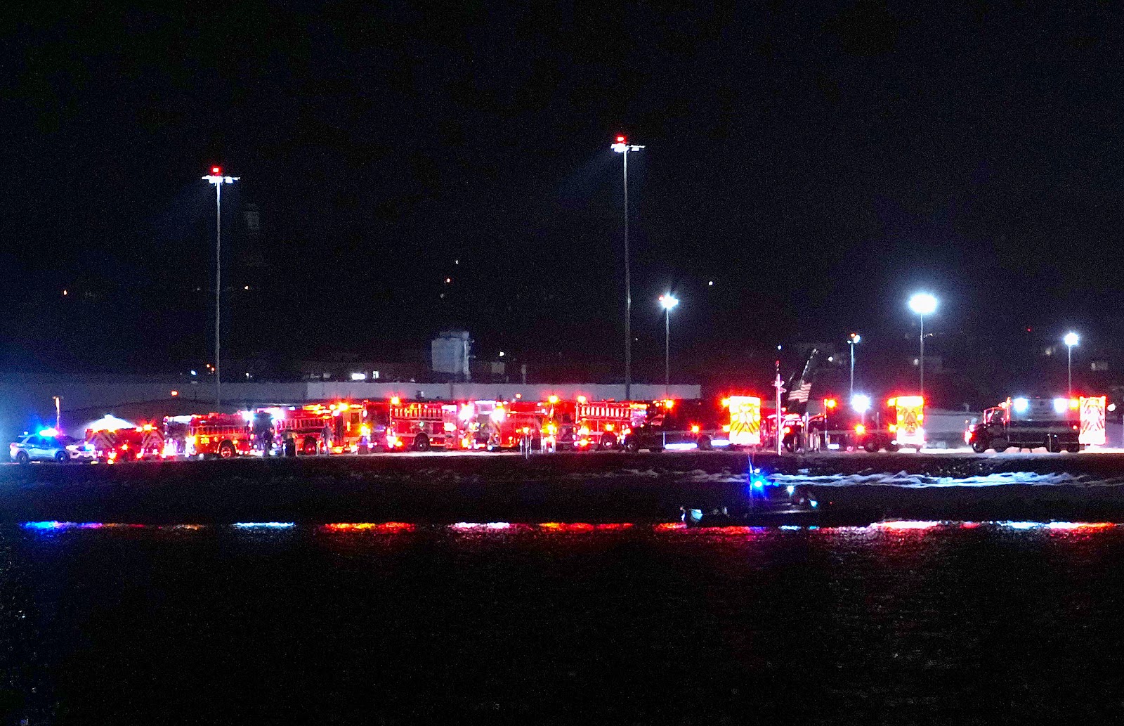 Emergency response units wait on the tarmac as search and rescue operations are underway concerning the crash in Washington, D.C., on January 29, 2025. | Source: Getty Images