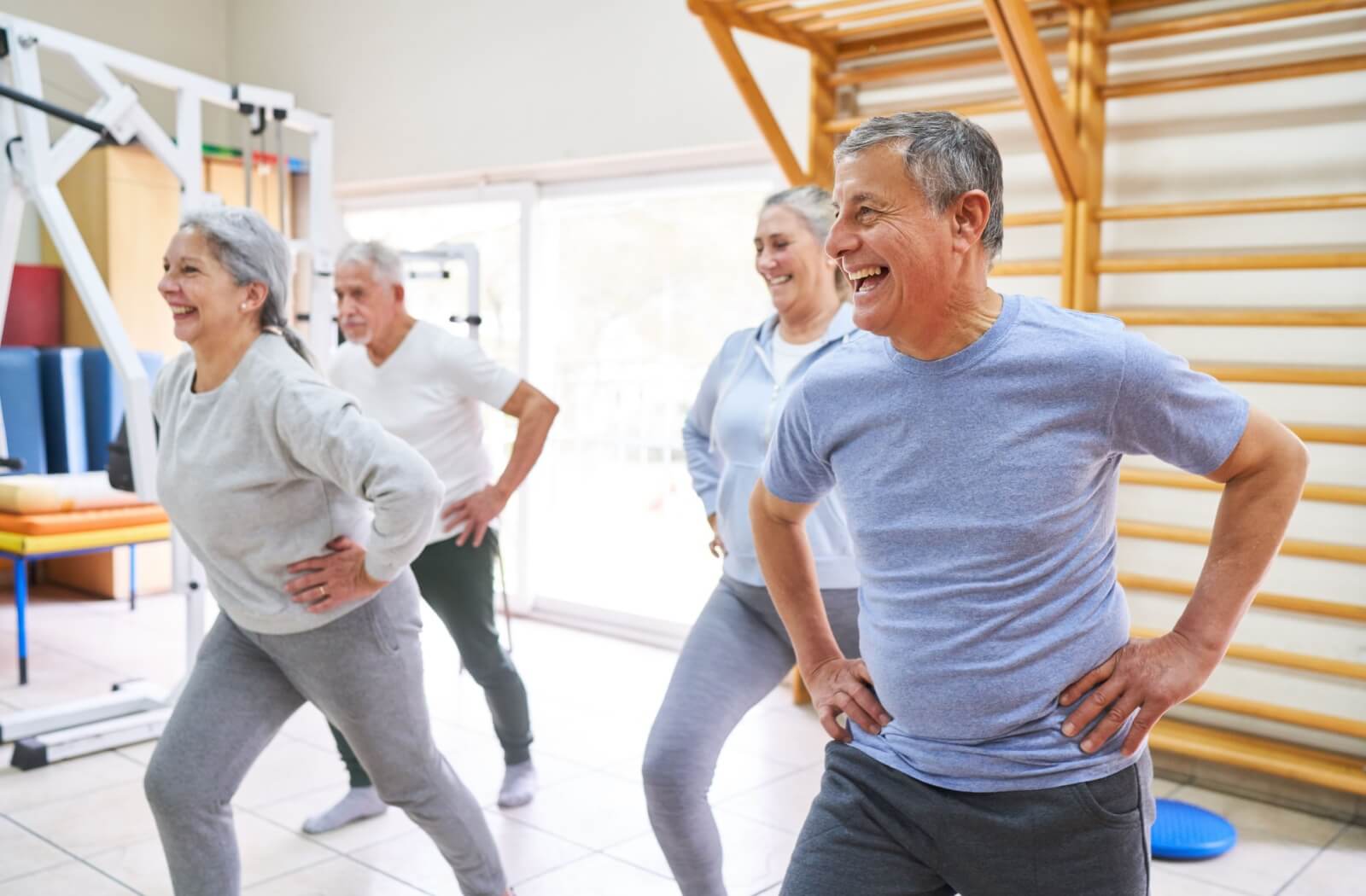 A group of seniors exercise to stay active while living in a senior living community.