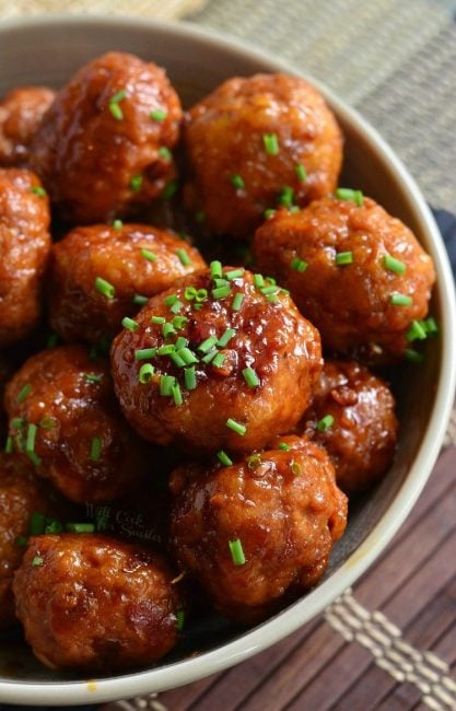 top view of meatballs in a bowl topped with chives