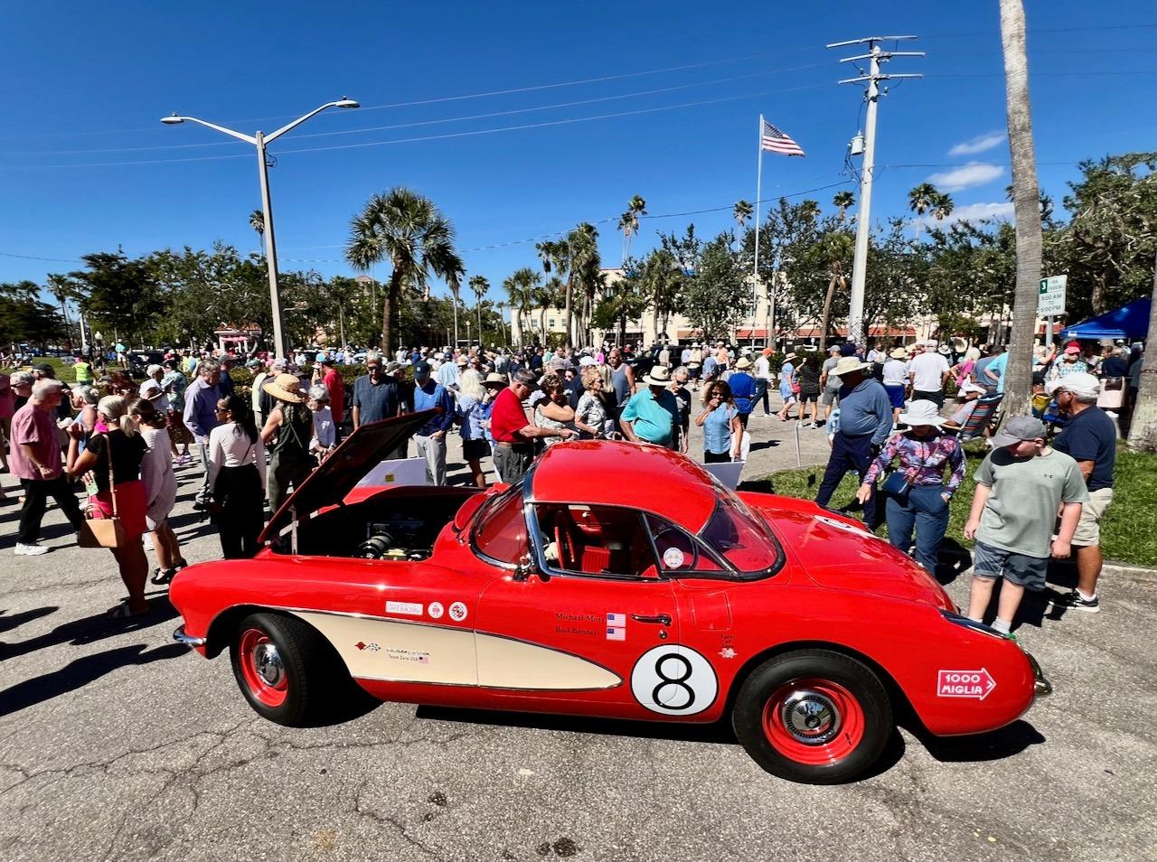 A red car with a number on it

AI-generated content may be incorrect.