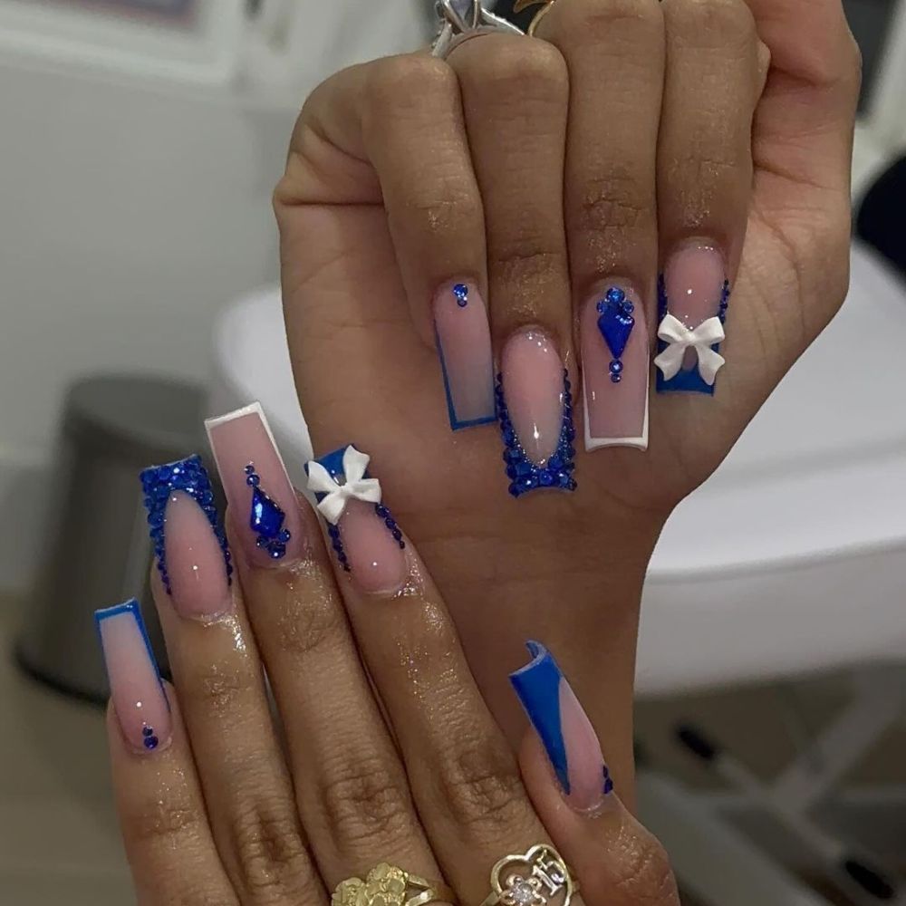 Close up of hands with blue winter nails having Cute French nail art