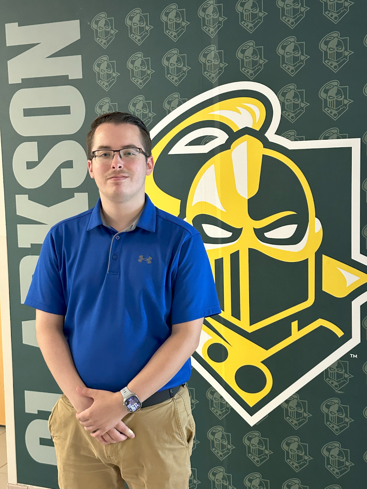 Zack Messier standing in front of Golden Knight mural.