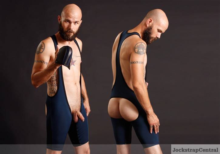 gay muscle pup shows off his dick and bare butt in cutouts gay fetish singlet while smiling at the camera for jockstrapcentral