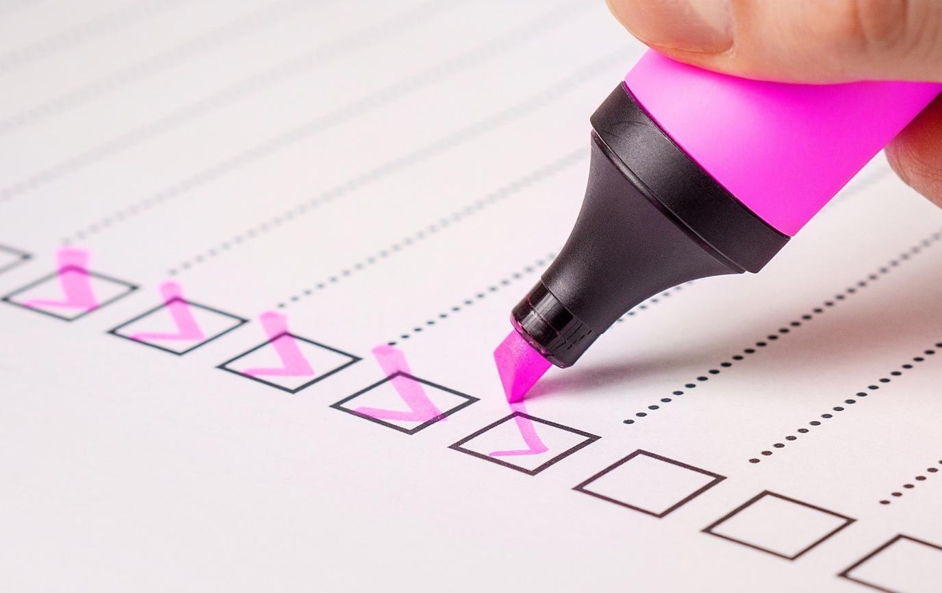 A hand with a pink highlighter on a checklist

Description automatically generated