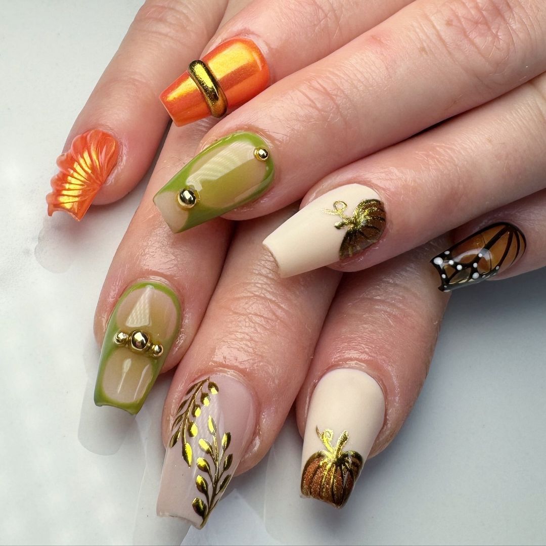 Close-up of hands with fall nail design having Seasonal Charms and Dangles