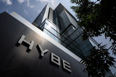 This  contain an image of  the hybbe logo is seen in front of an office building with trees and blue sky