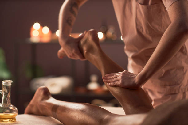 A runner receiving a sports massage therapy to reduce tightness and prevent running-related injuries.