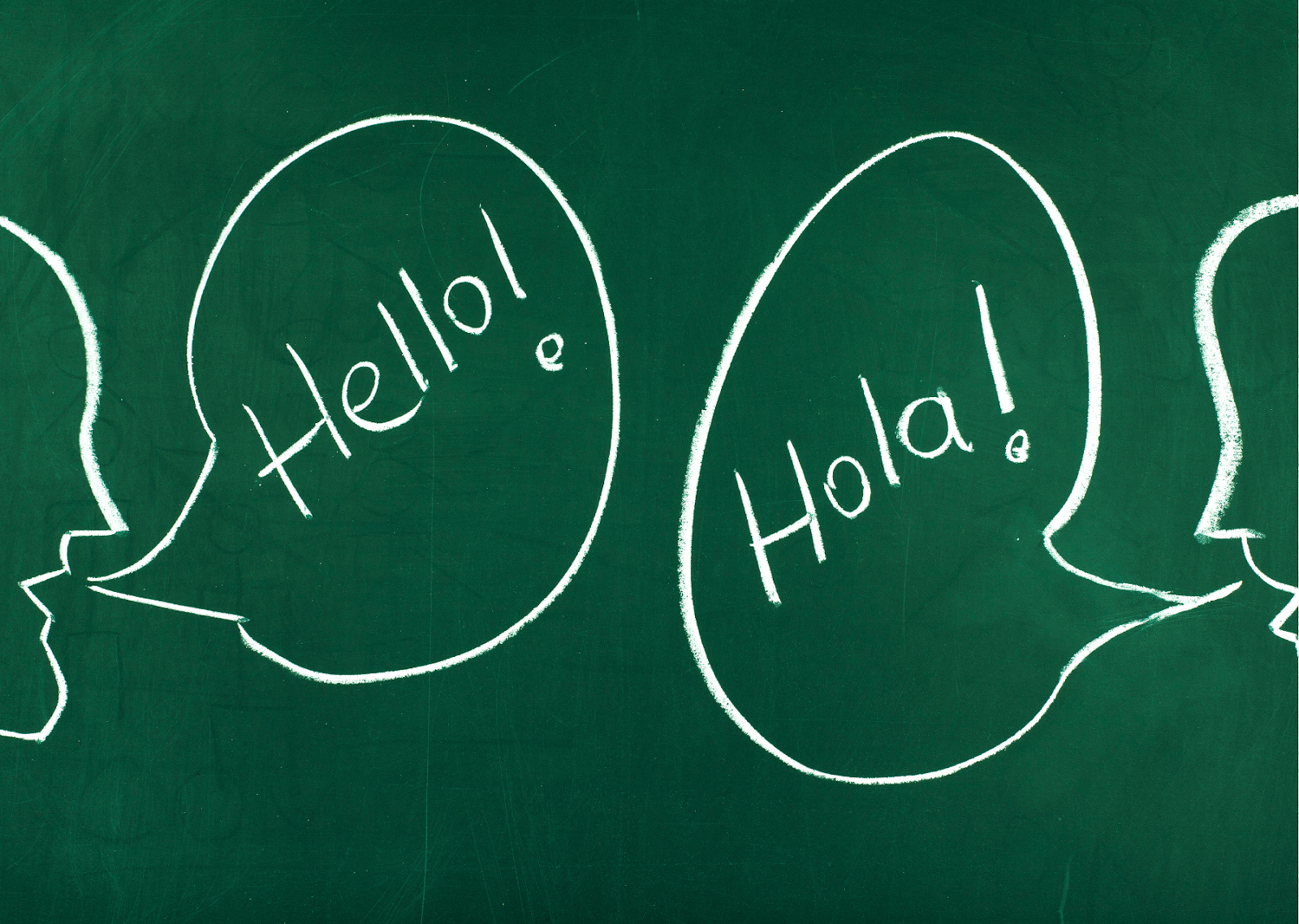 This image illustrates an unspoken rule for tourists in Spain: the importance of learning basic local phrases. The chalkboard shows two speech bubbles, one with "Hello!" and the other with "Hola!"—the Spanish equivalent of "Hello." This simple bilingual greeting underscores the value of familiarizing oneself with essential Spanish phrases. The green chalkboard and casual writing style suggest a helpful language tip for travelers, highlighting a key cultural insight for tourists in Spain.