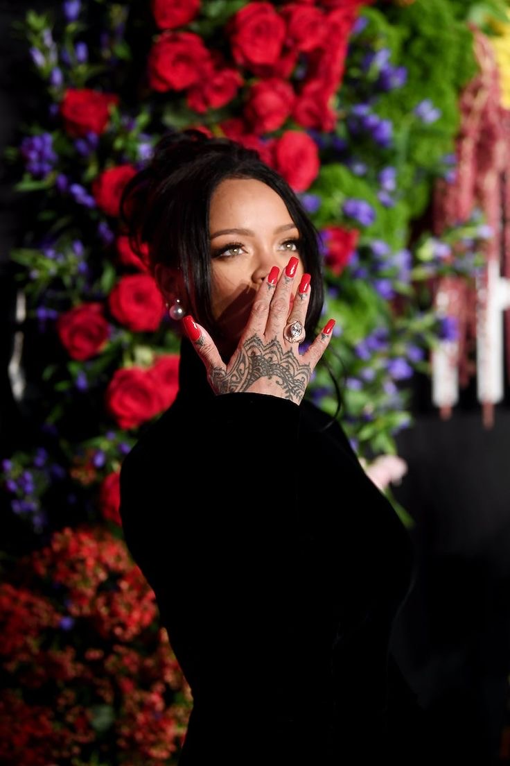 Alt Image: Rihanna flaunting bold nails at a Fenty event, perfectly complementing her effortless glamour via Bustle.com