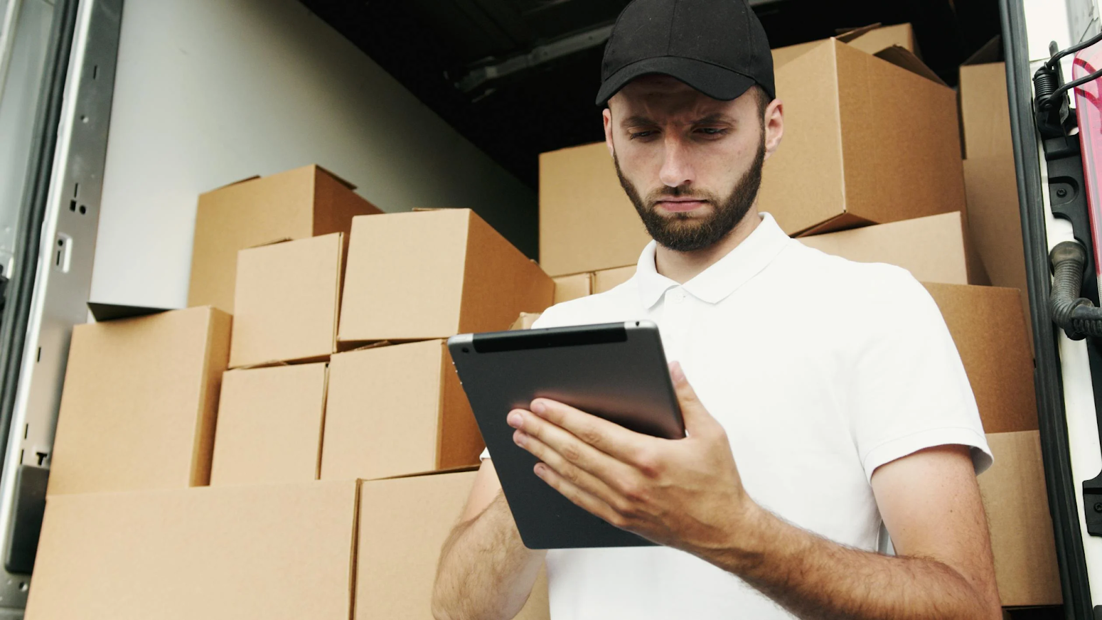 Man in white polo calculates shipping information