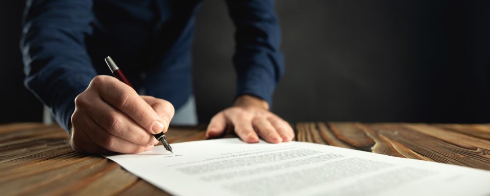 A business person signing a physical document