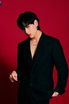 This contains an image of BamBam in a black suit is posing