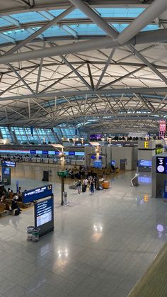 This  contain  an airport terminal with people waiting for their luggage to arrive or depart