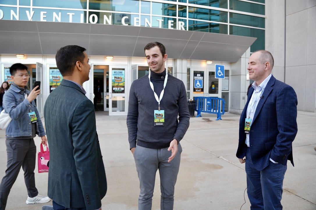 Men talking outside an arena