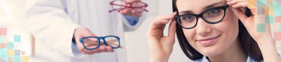 Woman trying on glasses frames as an optician hands her more options to try.